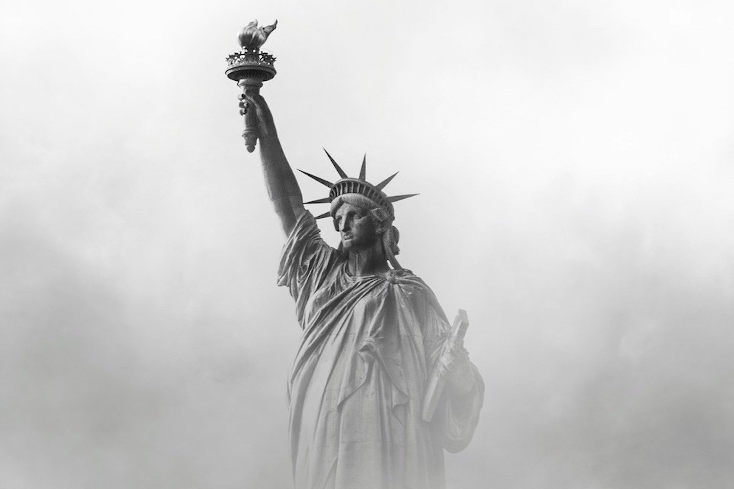 The Statue of Liberty, surrounded by mist.